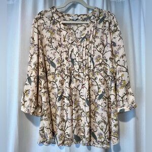 Beige blouse with floral print and peacocks